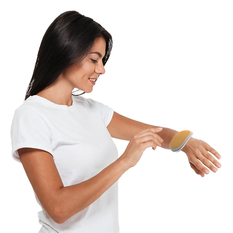 A girl is touching the Tickle Rock positioned on her wrist